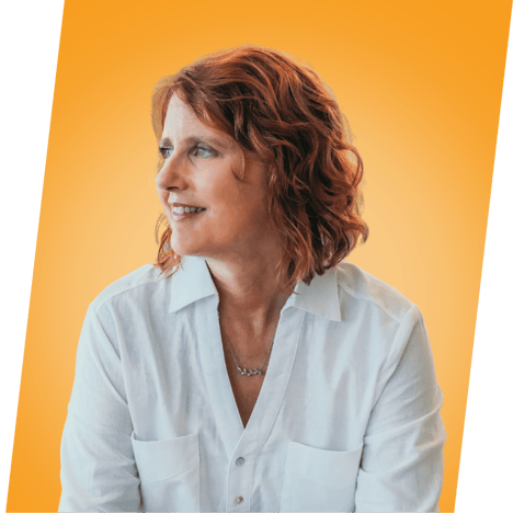 Janet Dore sits smiling.